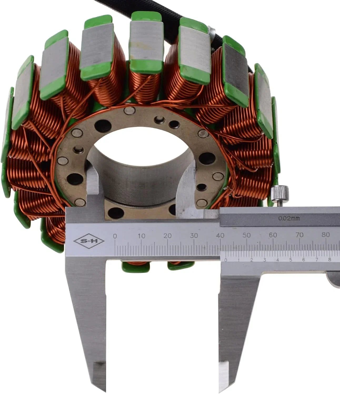 Motorcycle stator coil with copper windings measured by caliper on white background